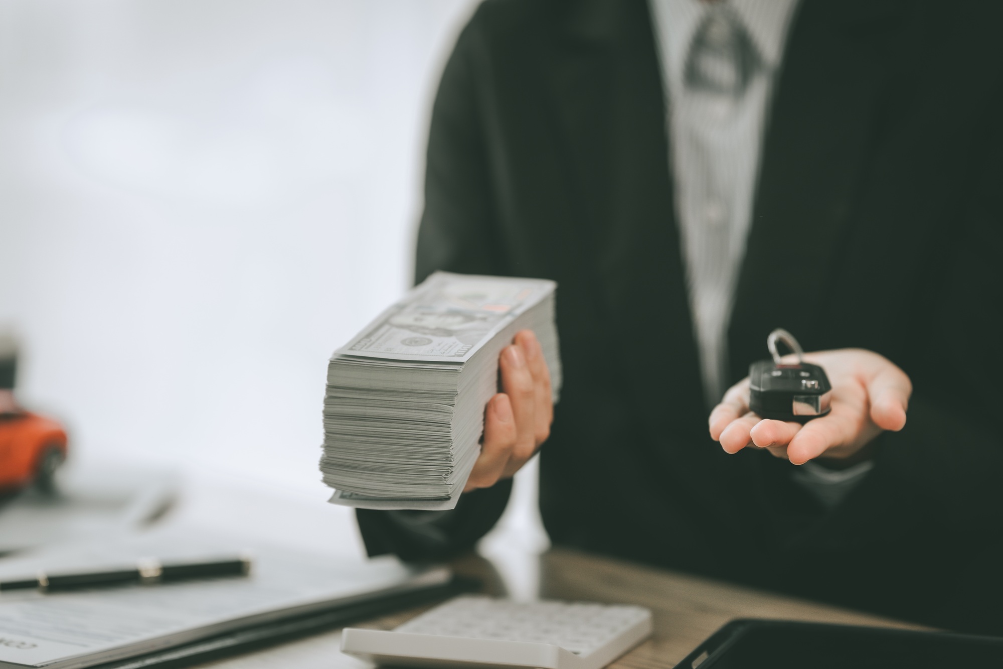 Pretty Asian businesswoman confidently handling funds for new vehicle loan, depicting financial